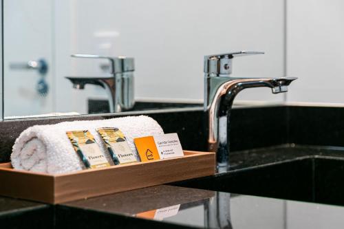 a bathroom sink with a towel holder next to a faucet at Apê no Belenzinho – Metrô Bresser / Pq. Belém in Sao Paulo