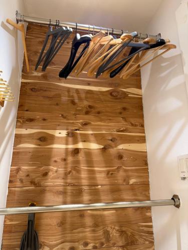 a walk in closet with wooden flooring and woodenadders at Studio Apartment with Garden Jersey City in Jersey City