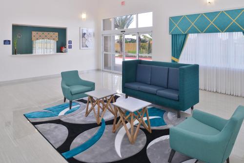 a waiting room with two chairs and a table at Regency Inn & Suites- NW Houston in Houston
