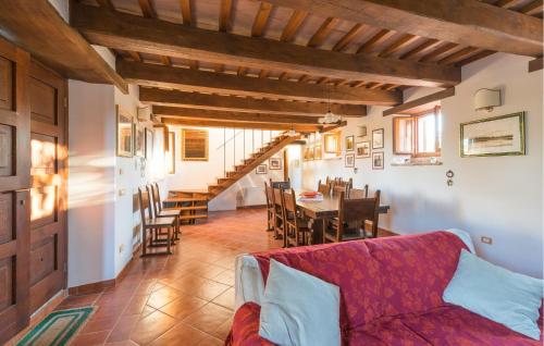 a living room with a couch and a dining room at Awesome Home In Valfornace With Private Swimming Pool, Can Be Inside Or Outside in Pievebovigliana