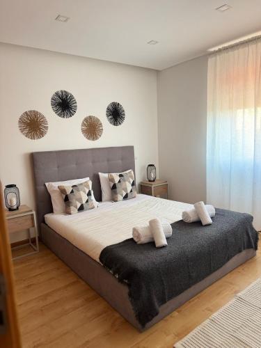 Un dormitorio con una cama grande con dos toallas encima. en Mãos n'Areia, en Ferrel