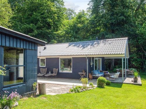 a blue house with a porch and a patio at Secluded Haven in Kelstrup - By Traum Ferienwohnungen in Kelstrup Strand