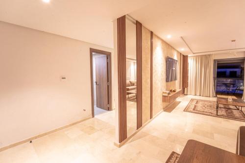a living room with a table and a large mirror at Modern apartment with pool view Tamaris in Tamaris