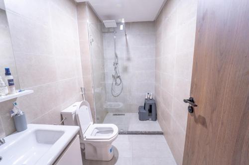 a bathroom with a shower and a toilet and a sink at Modern apartment with pool view Tamaris in Tamaris