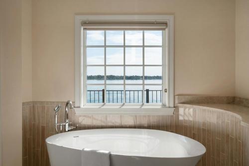 a bath tub in a bathroom with a window at St. Clair Inn in St. Clair