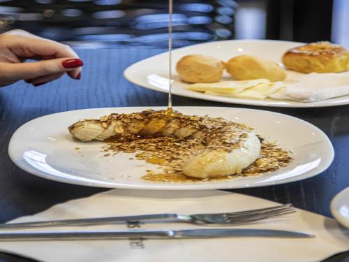 two plates of food on a table with food at ibis Sao Paulo Tatuape in Sao Paulo