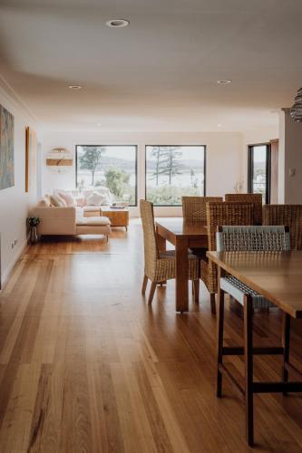 a living room with a table and chairs and a couch at Doric Dreams - Short Stroll to St Helens in St Helens