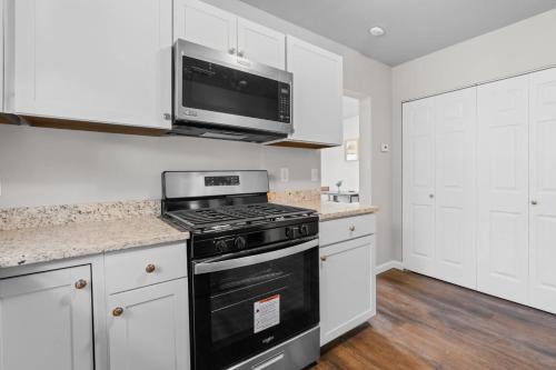 a kitchen with a stove and a microwave at Charming 1-Bedroom Retreat in Fort Worth in Fort Worth