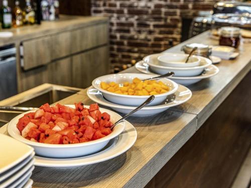 a buffet with bowls of food on a table at Ibis Torreon in Torreón