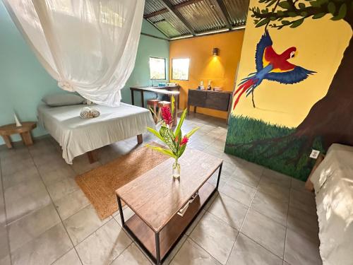 a living room with a vase of flowers on a table at El Cerrito in Puerto Jiménez