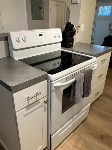 a kitchen with a white stove top oven at Davenport Dwellings Midtown Convenience in Omaha