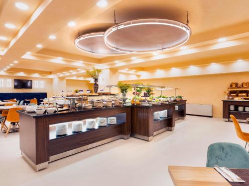 a buffet line with food on display in a restaurant at Mercure Istanbul Bakirkoy in Istanbul