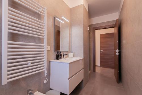 a bathroom with a white sink and a mirror at Residence Black Line - Affitti Brevi Italia in Foggia