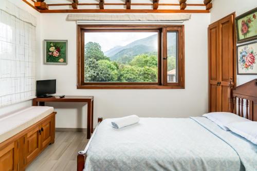 a bedroom with a bed and a window at La Heredad Villa de Leyva in Villa de Leyva