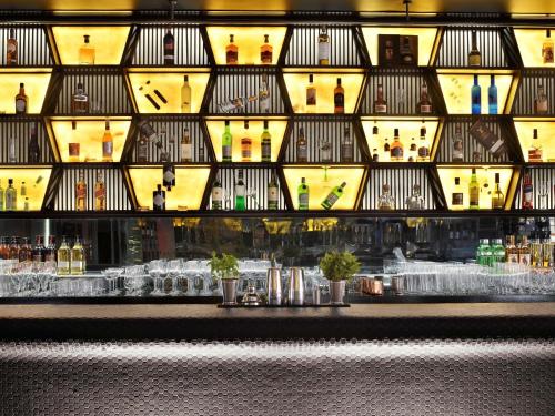 a facade of a building with bottles and glasses at Mövenpick Hotel Jumeirah Beach in Dubai