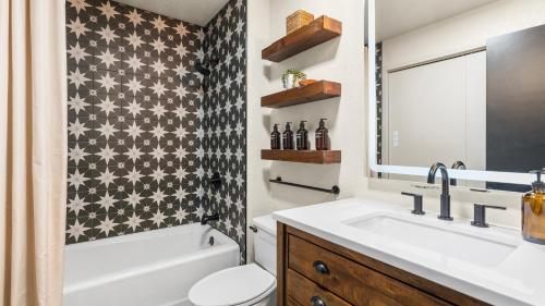 a bathroom with a sink and a toilet and a tub at Steps from Snowmass Village Fireplace Firepit Mountain Views Aspen Glow Retreat by AvantStay in Snowmass Village