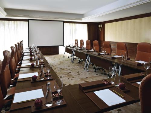 a conference room with a long table and chairs at Mövenpick Hotel City Star Jeddah in Jeddah