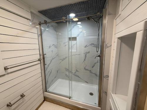 Highland LakesTop Luxe Oasis -Ski, Hike, Firepit, Spa, Golf的浴室里有玻璃门的淋浴间