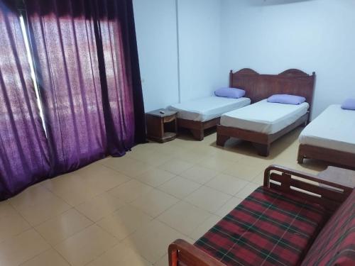 a room with two beds and a couch in it at MARIA HOSTEL FOREIGNERS ONLY-CRISS RESORT-NAAMA BAY-CITY CeNTER in Sharm El Sheikh