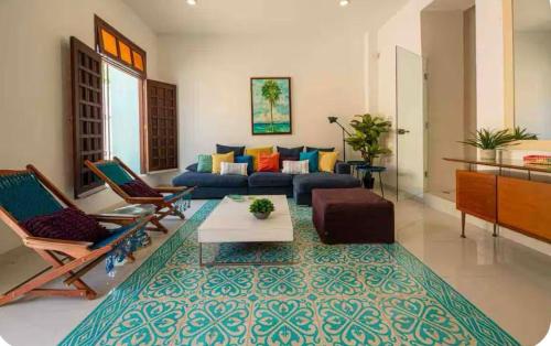 a living room with a blue couch and chairs at Villa Nelly in Campeche