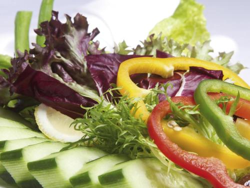 a salad with peppers and vegetables on a plate at Movenpick Hotel & Residences Hajar Tower Makkah in Makkah