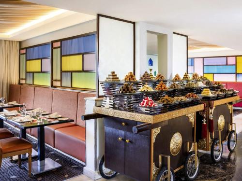 a buffet of food on a table in a restaurant at Movenpick Hotel & Residences Hajar Tower Makkah in Makkah