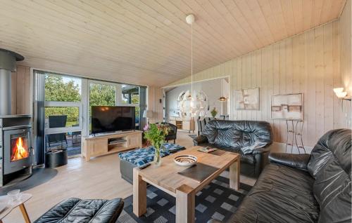 a living room with a couch and a table at Stunning Home In Tarm With Sauna in Højsand