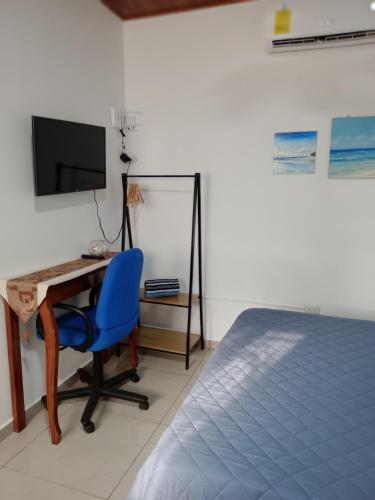 a bedroom with a desk and a blue chair at Sunzal Refugio Perfecto-3 in El Sunzal