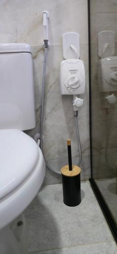 a bathroom with a white toilet and a shower at Chalé Pôr do Sol in Cunha