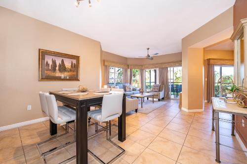 a dining room and living room with a table and chairs at Pura Vida in Orlando
