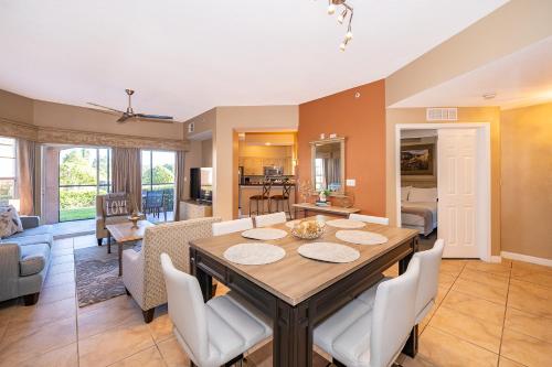 a dining room and living room with a table and chairs at Pura Vida in Orlando