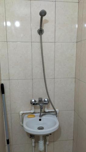 y baño con ducha y lavabo. en Хостел Москва, en Aktobe