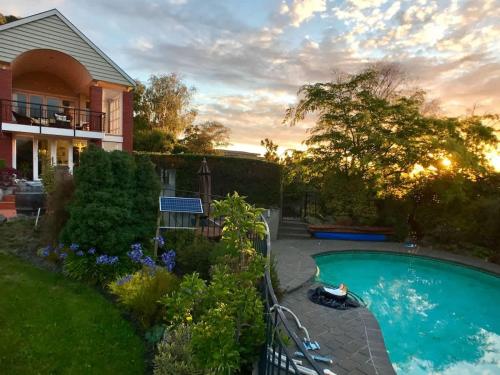 a house with a swimming pool in a yard at The cashmere bothy in Christchurch