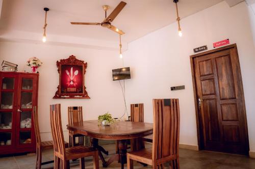 a dining room with a wooden table and chairs at Sea wind in Mirissa