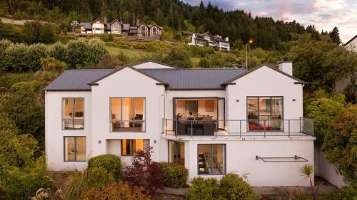 a white house with a black roof at The Queenstown Bothy in Queenstown