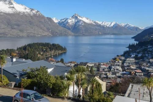a view of a town with a lake and mountains at The Queenstown Bothy in Queenstown