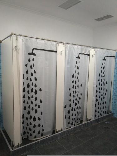 a white wall with black designs on it at Hostel Raymundo in Évora