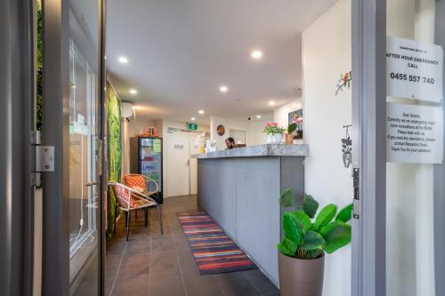 a hallway with a counter and a bar in a room at Motel 10 in Bankstown