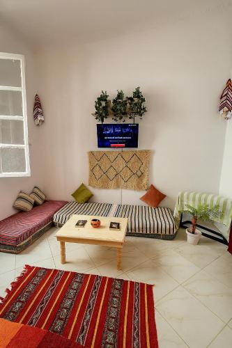 a living room with two couches and a table at Kasbah Nights Retreat and best breakfast offers - Entire House in Tangier