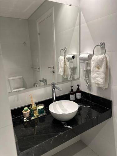 a bathroom with a sink and a mirror at Vista al Rio by renty in Encarnación