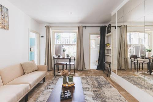 a living room with a couch and a table at Sleeps 5! Parking, WiFi & Parking, 4 Mins To Station, NEWLY REFURBISHED!! in London