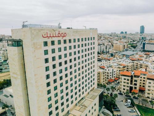 a building with a bulovo sign on top of it at Mövenpick Hotel Amman in Amman