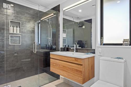 a bathroom with a sink and a shower at Luxury in Silverstream in Kaiapoi