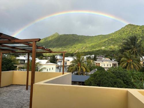a rainbow in the sky over a city at 5 Spots Studio in La Gaulette