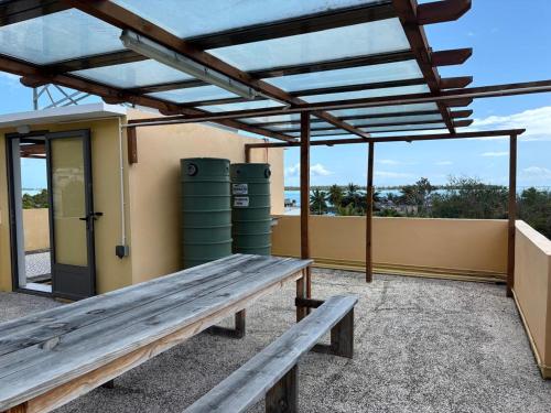 a picnic table on a patio with two green barrels at 5 Spots Studio in La Gaulette