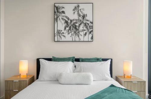 a bedroom with a bed with two lamps on it at Luxury Indoor Pool, Jacuzzi, Sauna and Steam in Melbourne
