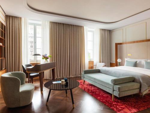 a hotel room with a bed and a desk at Raffles Europejski Warsaw in Warsaw