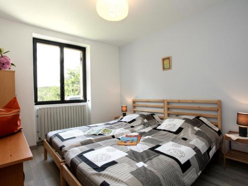 a bedroom with a large bed in a room at Gîte charmant à Groléjac avec parking, WiFi et jardin clos - FR-1-616-428 in Groléjac