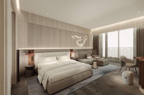 a bedroom with a large bed and a living room at The Reserve Hotel Luoyang, Curio Collection By Hilton in Luoyang