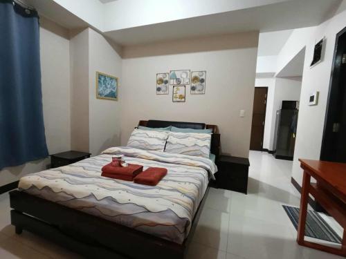 a bedroom with a bed with two towels on it at Condo Unit walking distance to Manila Airport (NAIA Terminal 3) in Manila